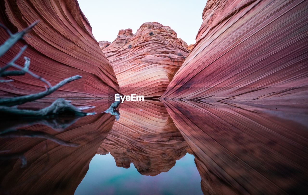 Rock formations reflecting on calm lake