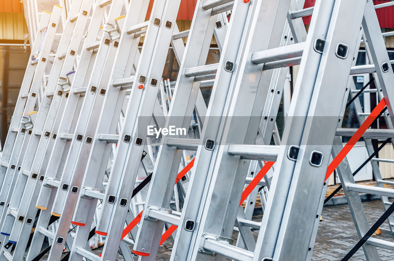 Folding metal aluminum ladders installed in row for sale