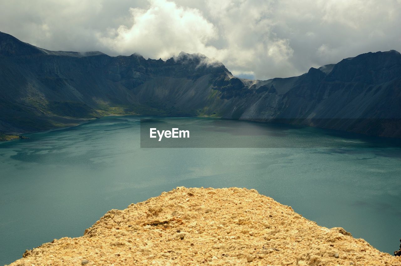 Scenic view of lake against cloudy sky