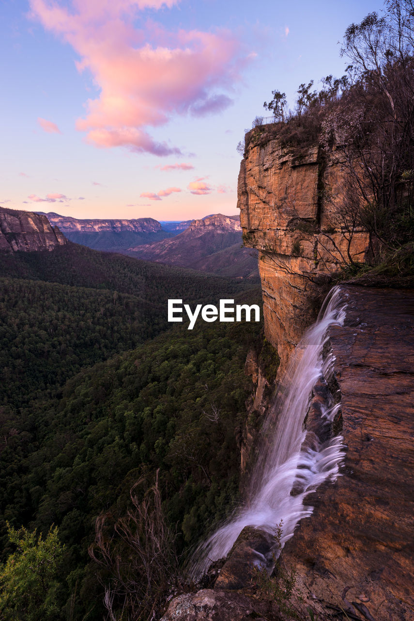 VIEW OF WATERFALL AGAINST SKY