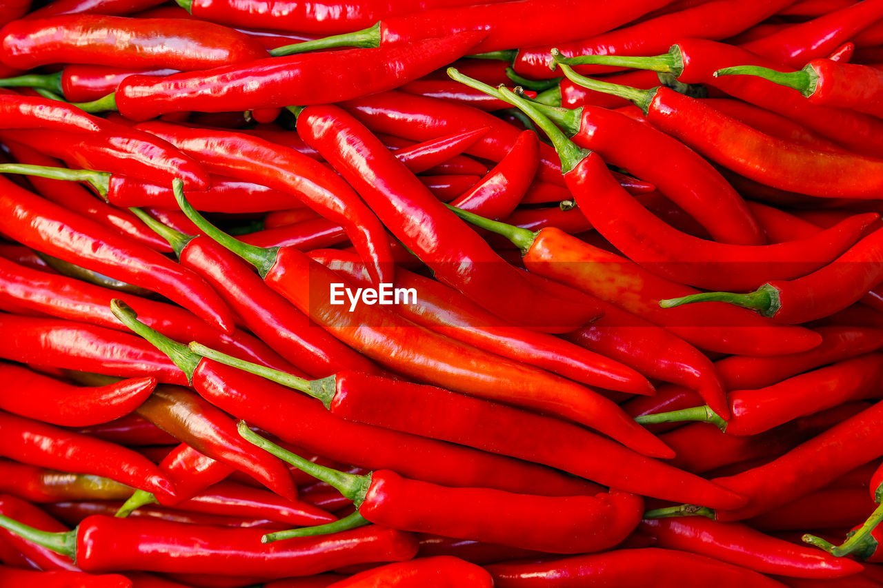FULL FRAME SHOT OF RED CHILI PEPPERS AT MARKET