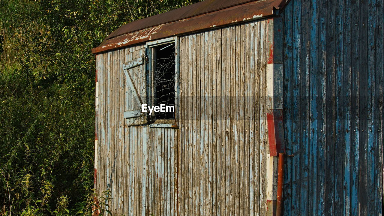 CLOSED WOODEN DOOR OF BUILDING