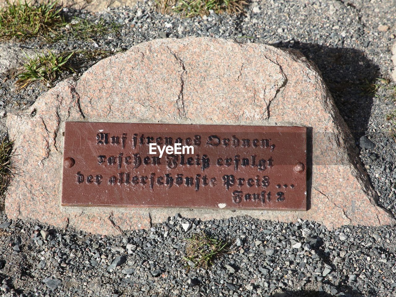 HIGH ANGLE VIEW OF TEXT ON STONE
