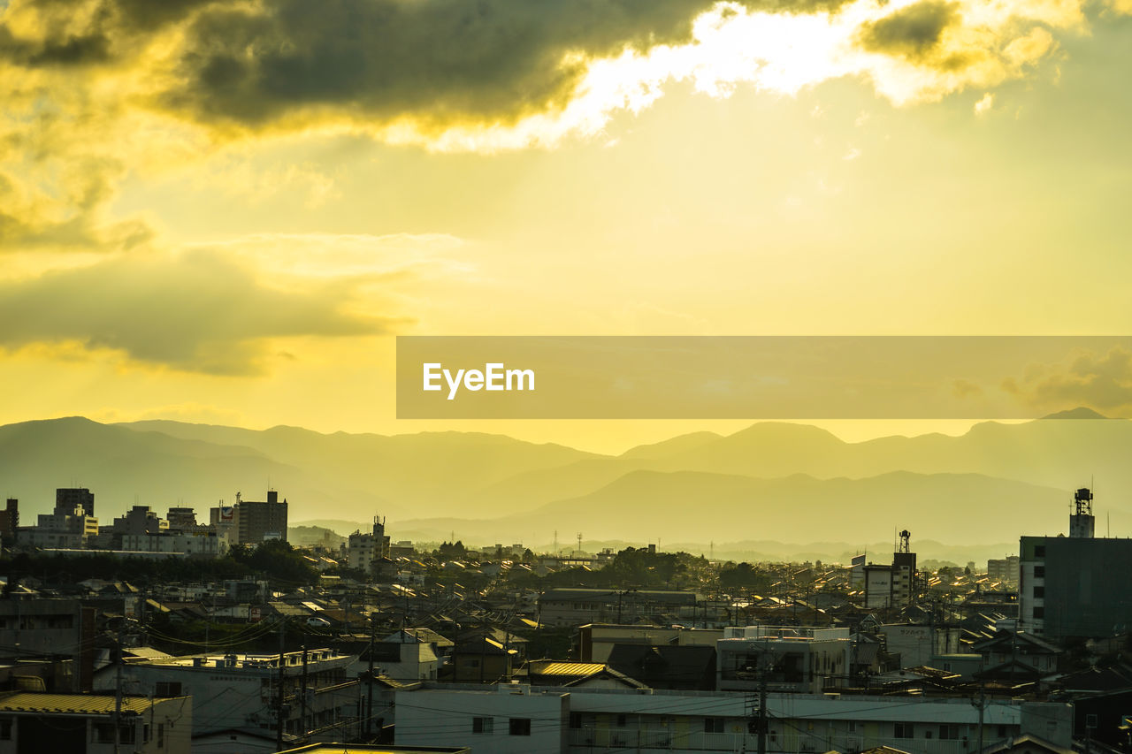 high angle view of buildings against sky during sunset