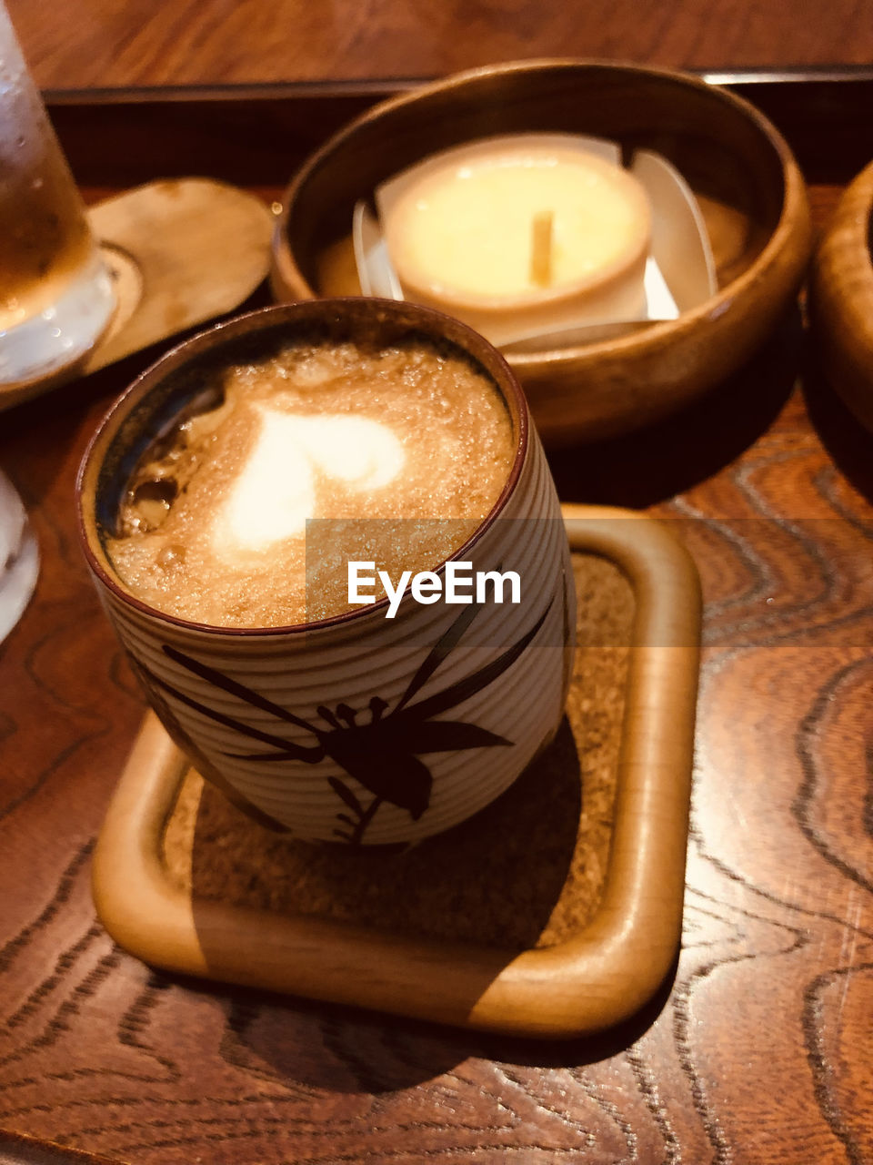 candle, food and drink, lighting, drink, indoors, no people, food, refreshment, high angle view, still life, table, heat, wood, close-up, burning, illuminated, cup