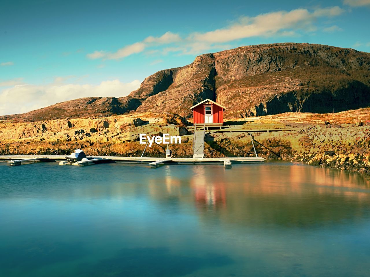 BUILDING BY LAKE AGAINST SKY