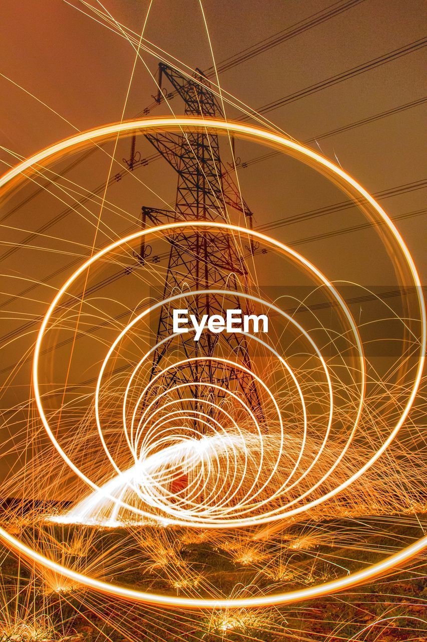 Close-up of light trails against sky at night