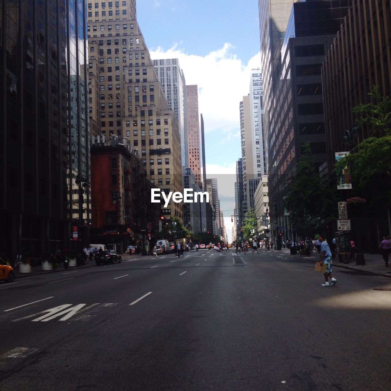 Empty road along buildings