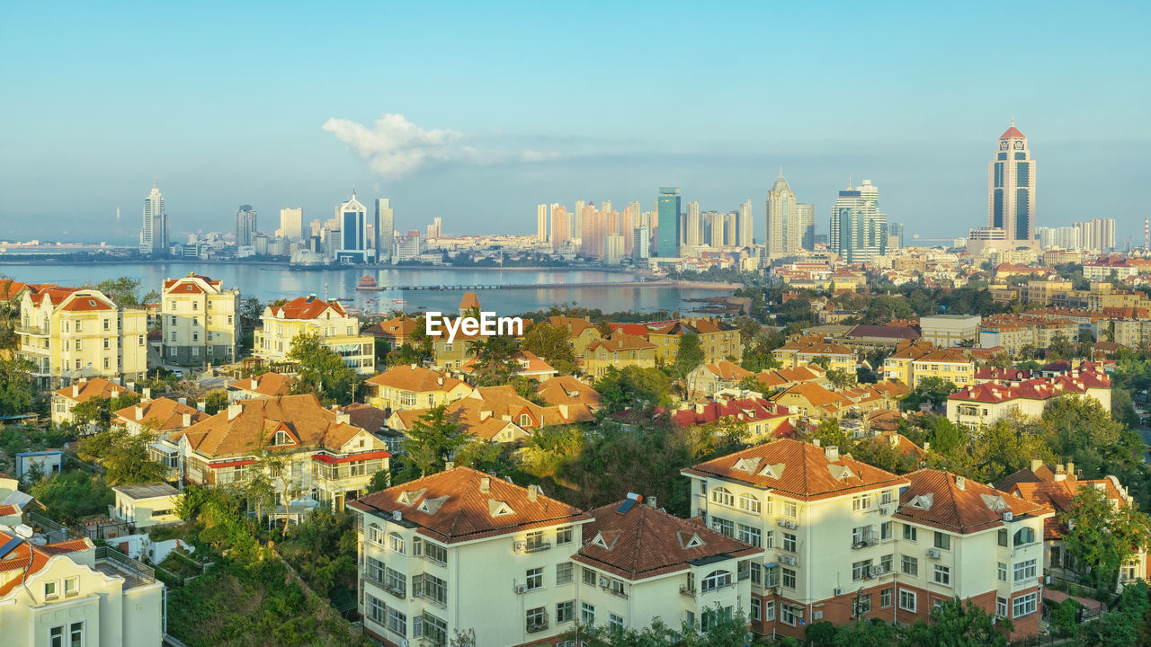 A view of the red roofs of downtown qingdao and tourist landmarks from the top of the hill.