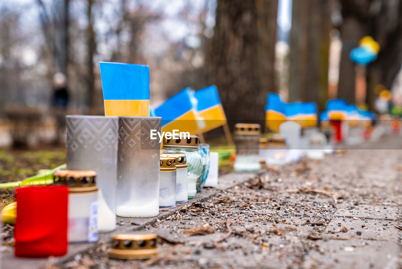 Thousands candles and flowers standing on the street during the war in ukraine