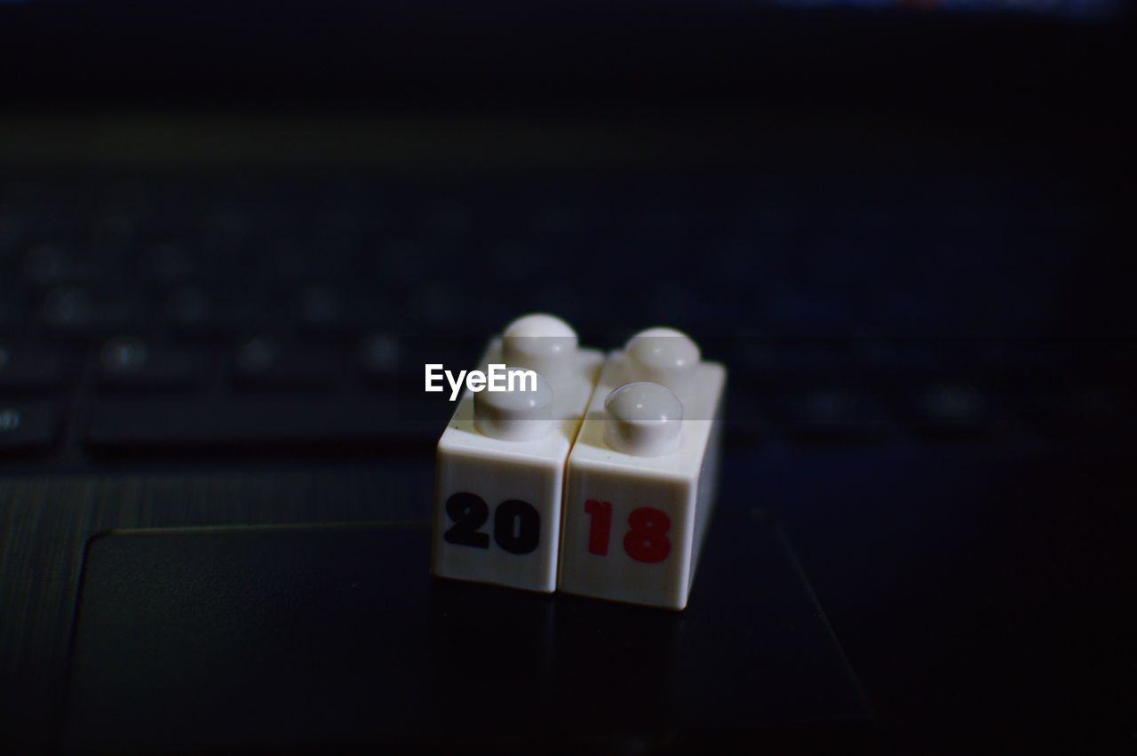 Close-up of toy blocks with number 2018 on laptop