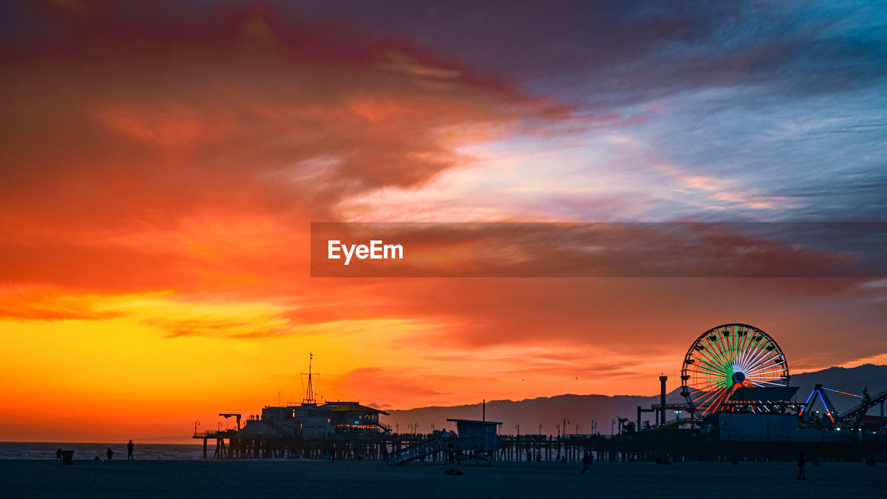 scenic view of sea against cloudy sky during sunset