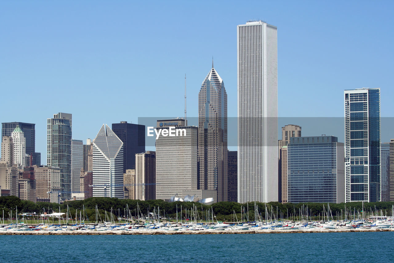 Modern buildings in city against clear sky