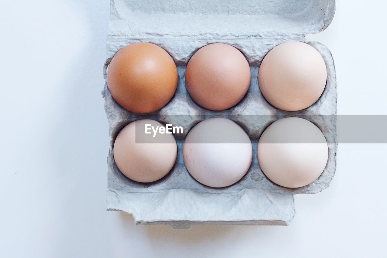 High angle view of eggs in carton on table