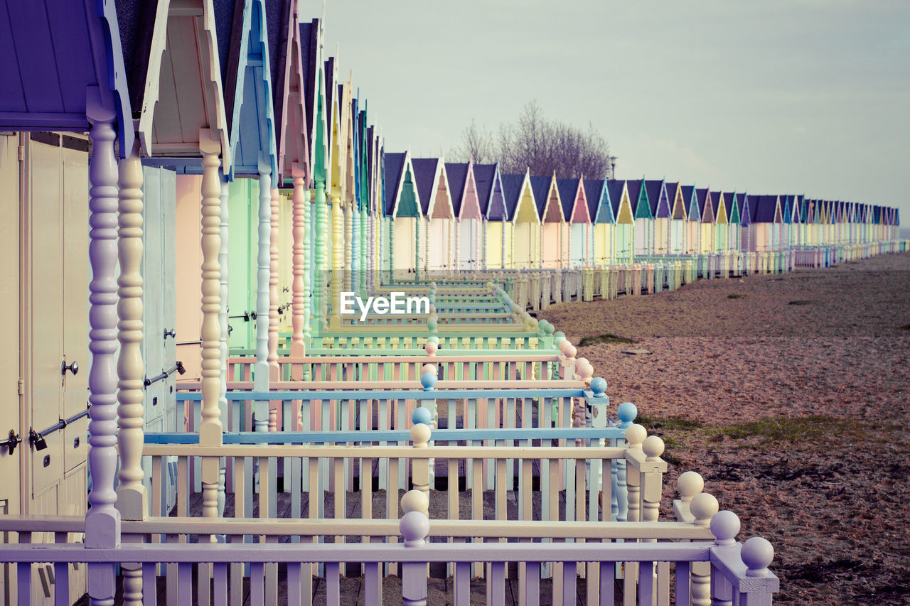 A view of typical english style colourful beach huts on the island of west mersea in the uk.