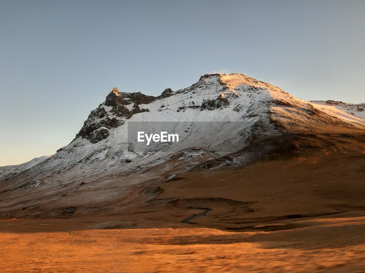 Scenic view of snow covered mountain against sky