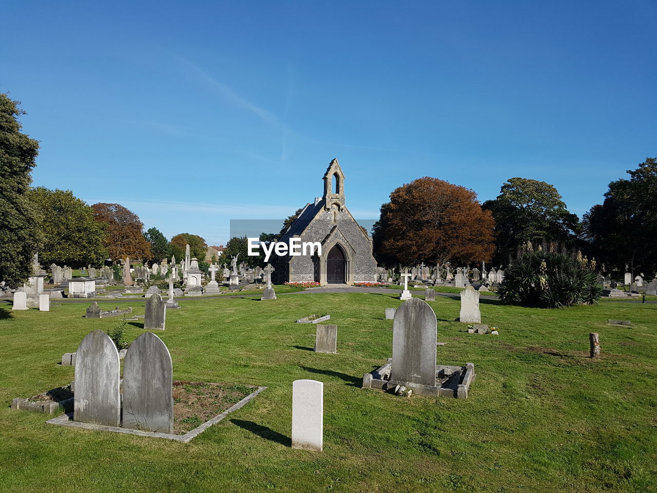 View of cemetery against clear blue sky