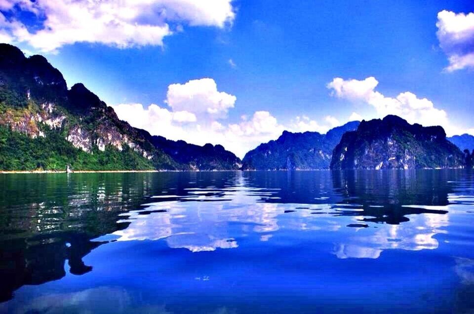 SCENIC VIEW OF LAKE WITH MOUNTAINS IN BACKGROUND