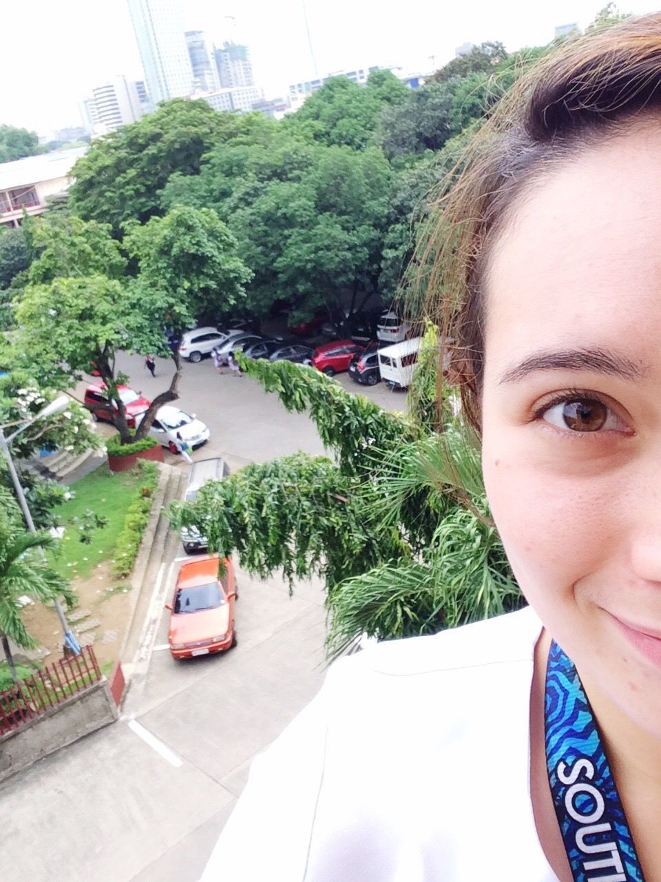 Cropped image of young woman against city street