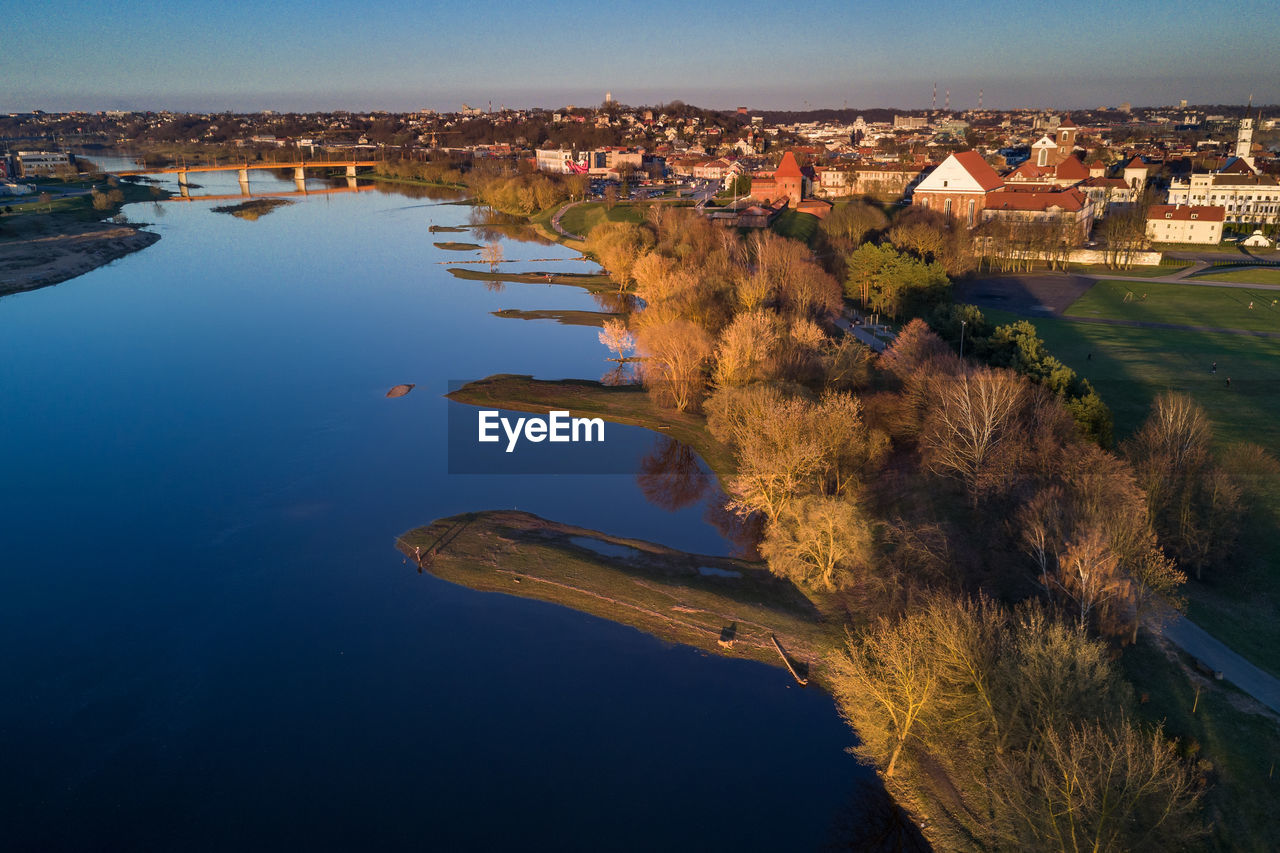 High angle view of river by cityscape against sky