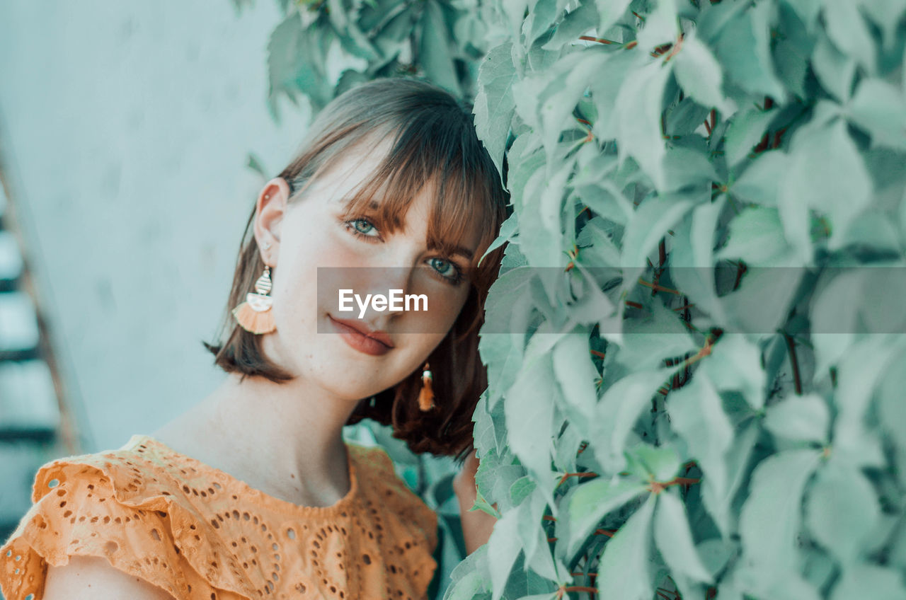 Portrait of woman beautiful woman standing by plants outdoors