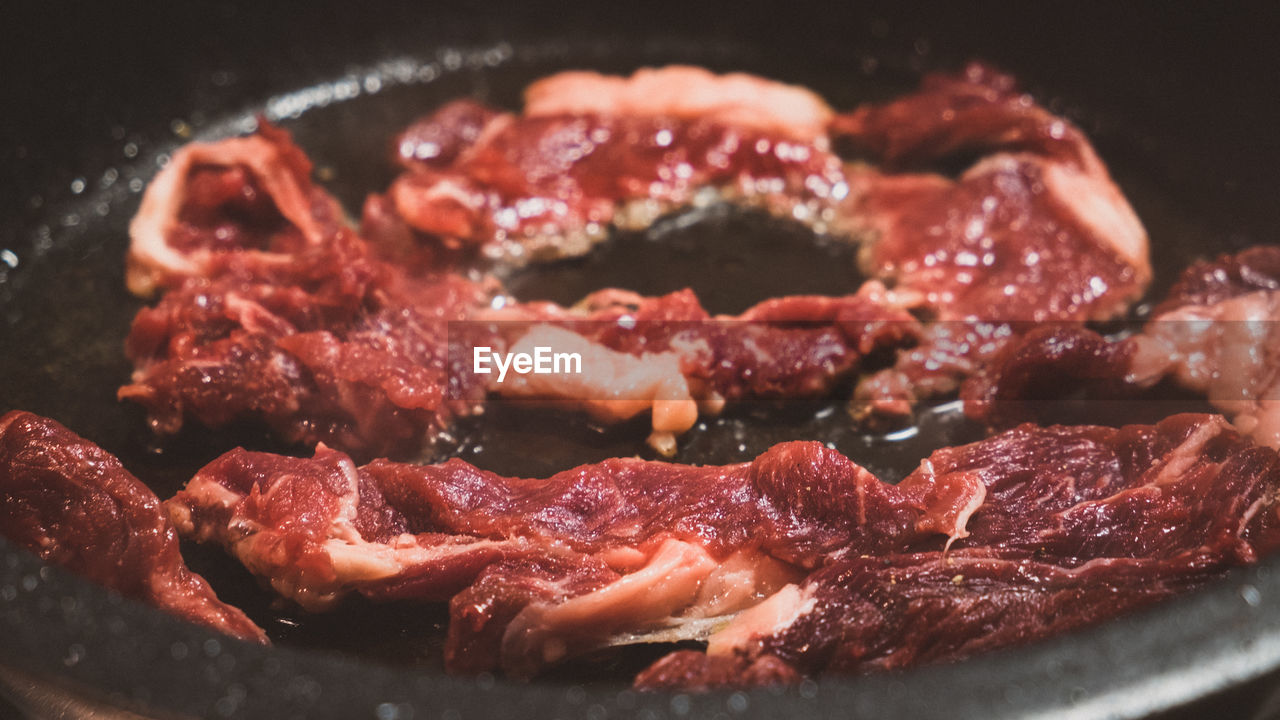 Close-up of meat in cooking utensil