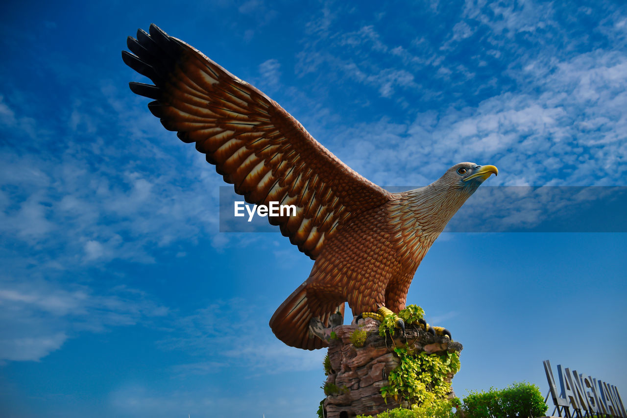 Eagle square or dataran lang a large sculpture of a reddish brown eagle to take flight