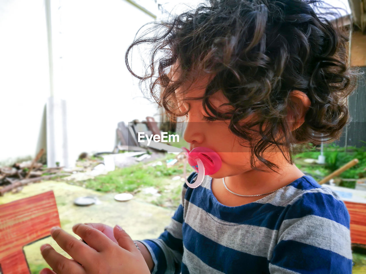 Close-up of girl sucking pacifier