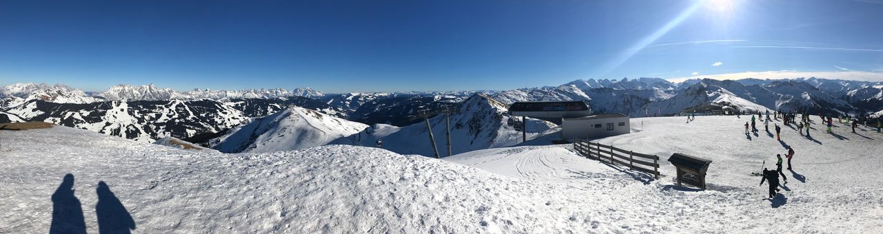 PANORAMIC SHOT OF SNOWCAPPED MOUNTAIN AGAINST BLUE SKY