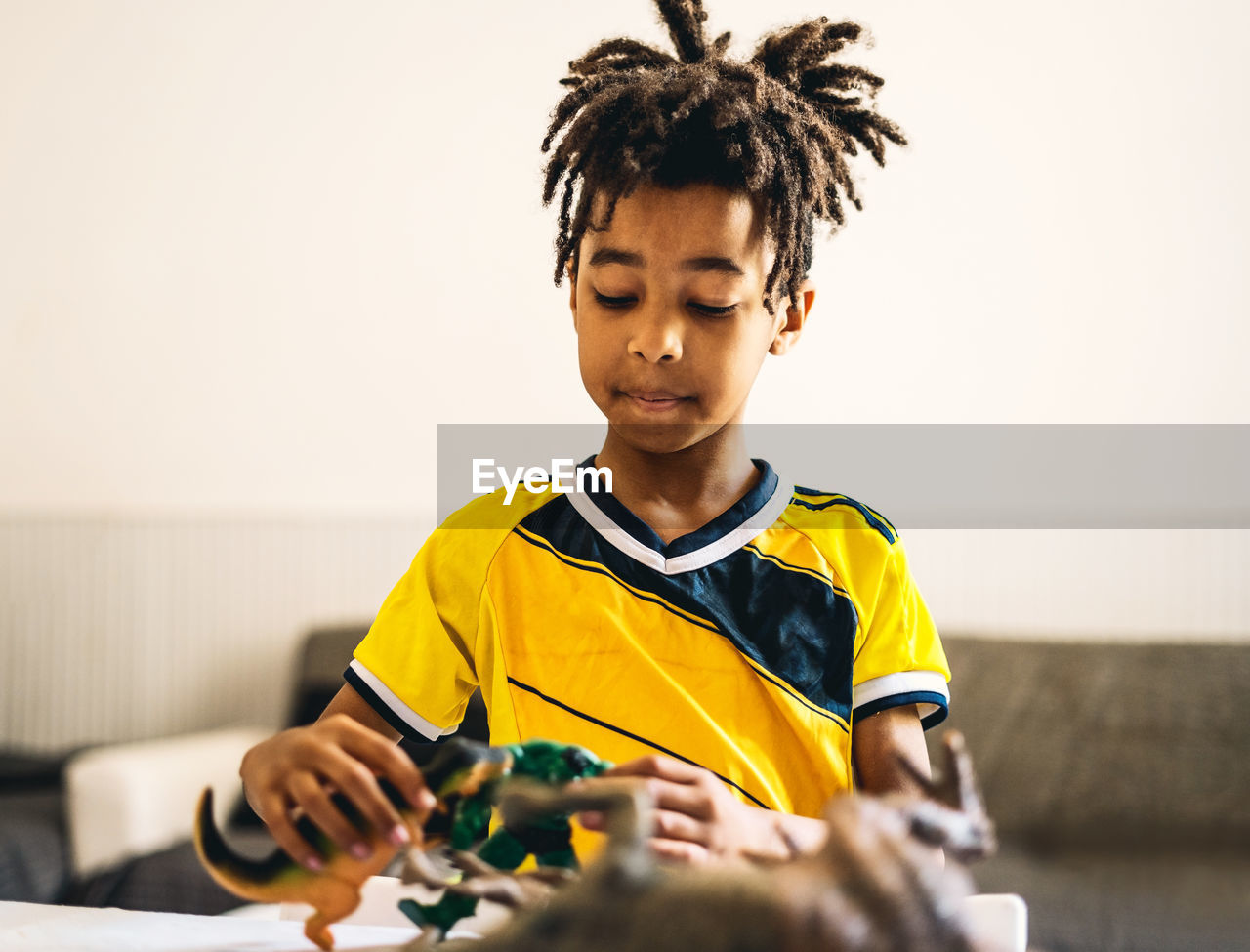 Boy playing with toys at home