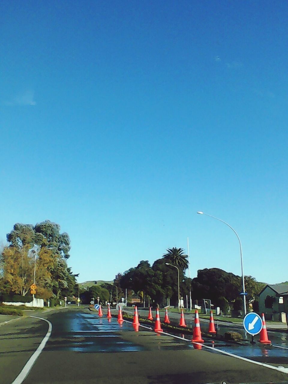 ROAD AGAINST CLEAR BLUE SKY