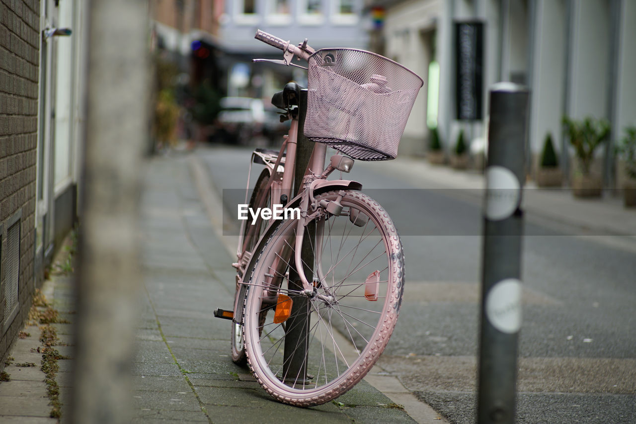 Bicycle parked on sidewalk in city