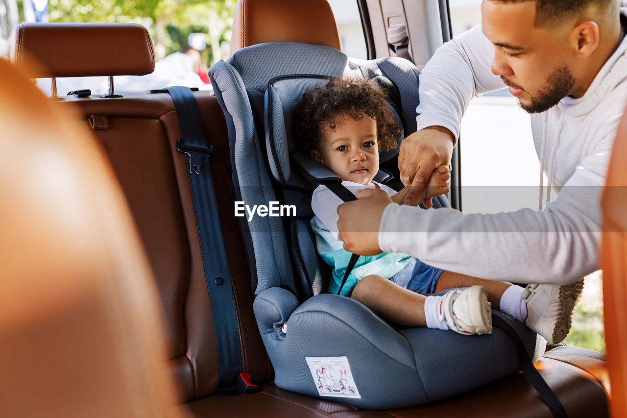 Father with son sitting in car