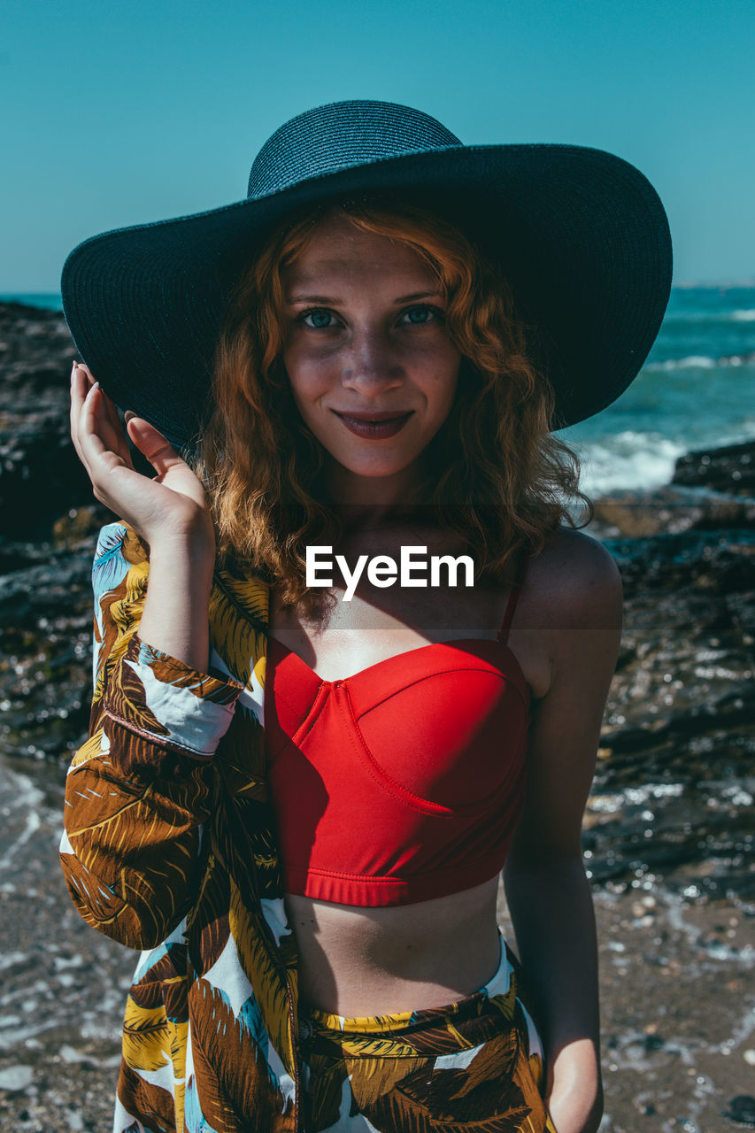 Portrait of fashionable woman standing on beach