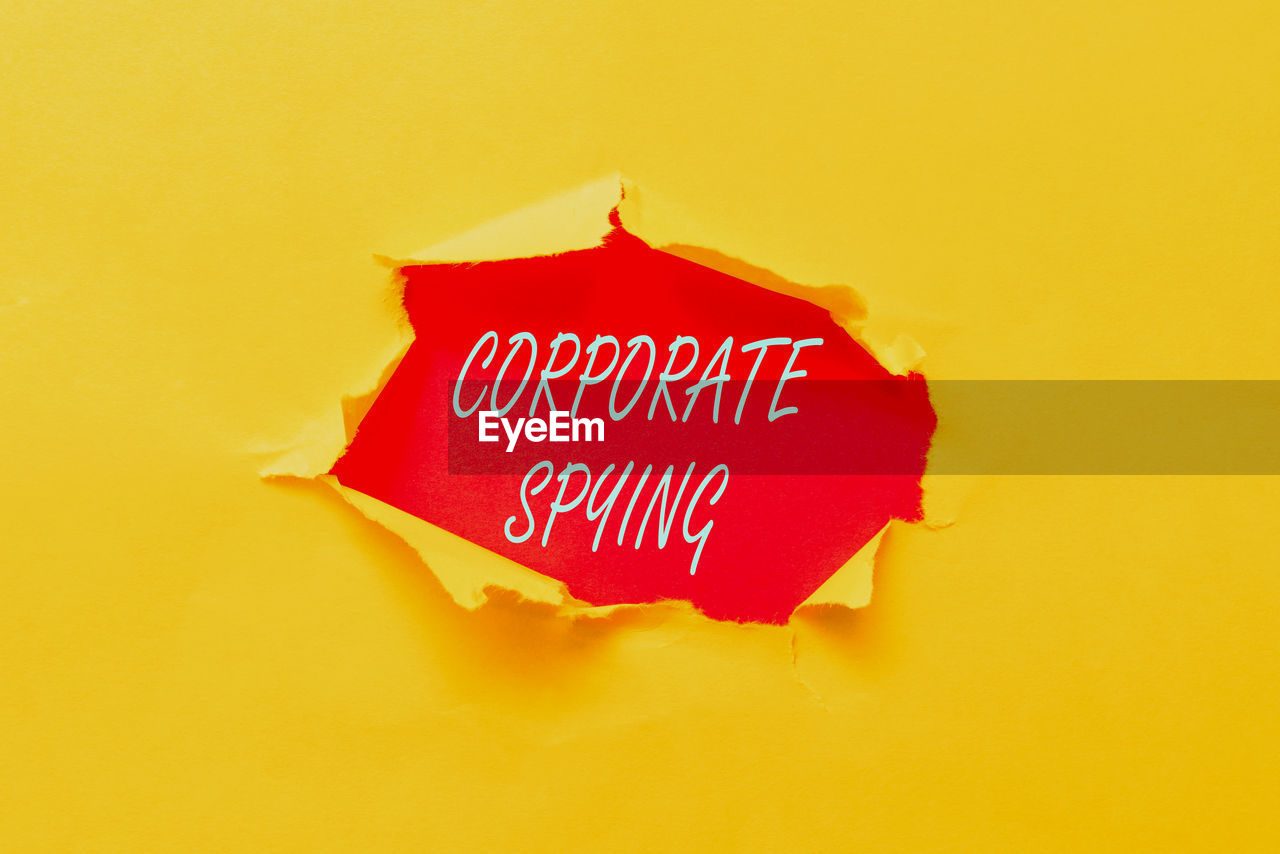 CLOSE-UP OF TEXT AGAINST YELLOW WALL