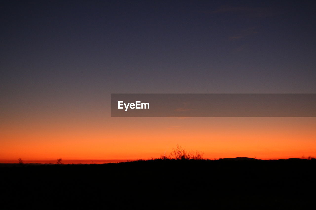 SILHOUETTE LANDSCAPE AGAINST SKY DURING SUNSET