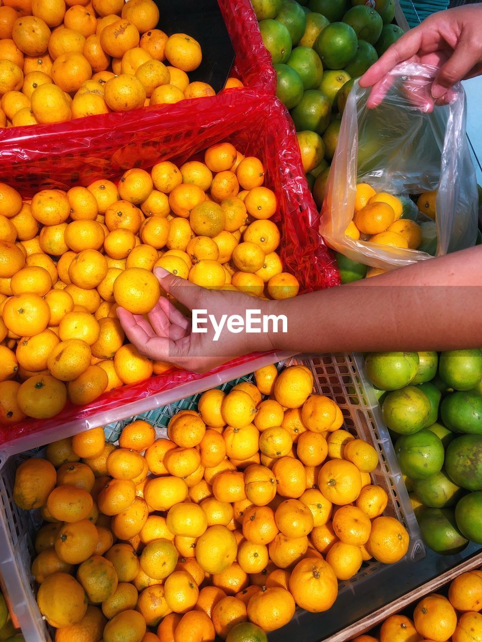 Fruits for sale at market stall sometime is picking fresh orange for good health 