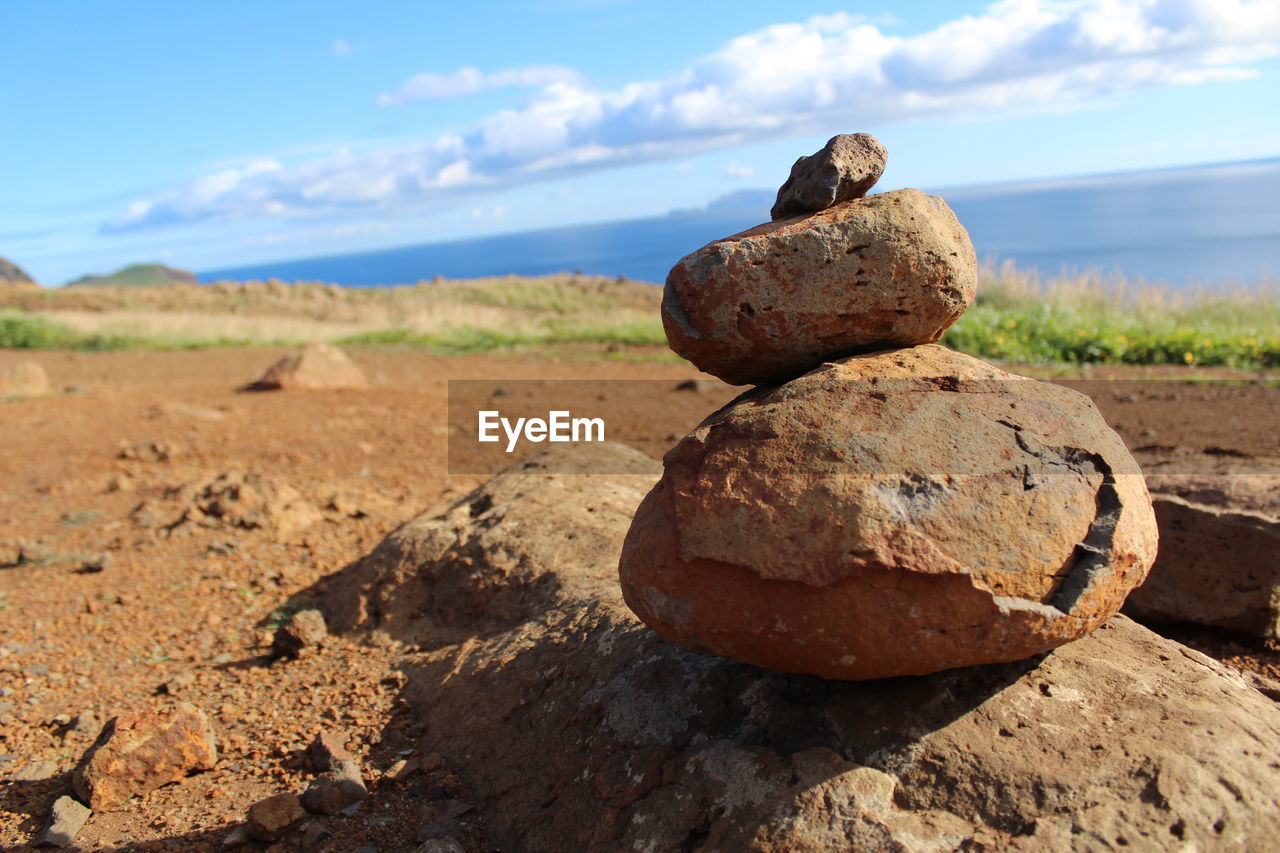 Stack of rocks on beach against sky