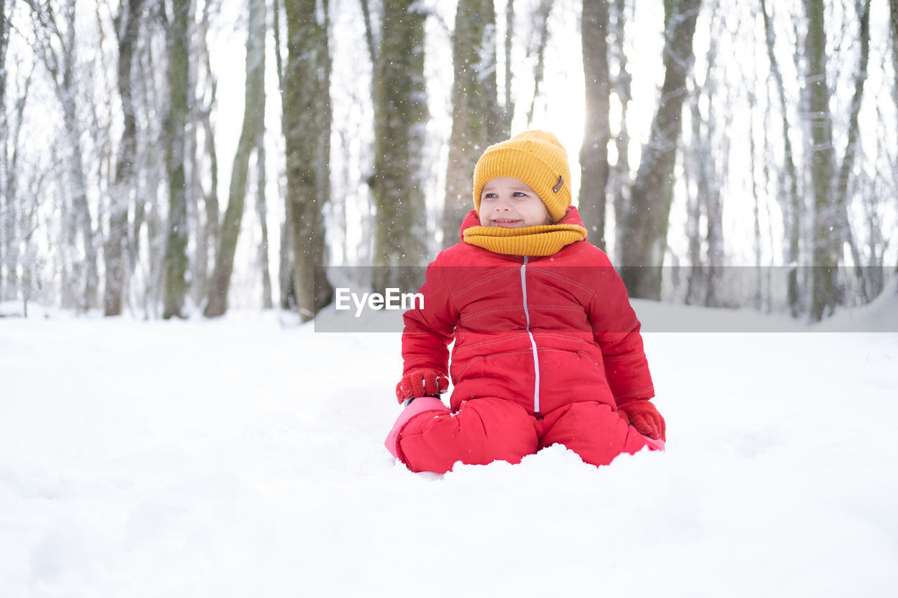 rear view of woman standing on snow covered field