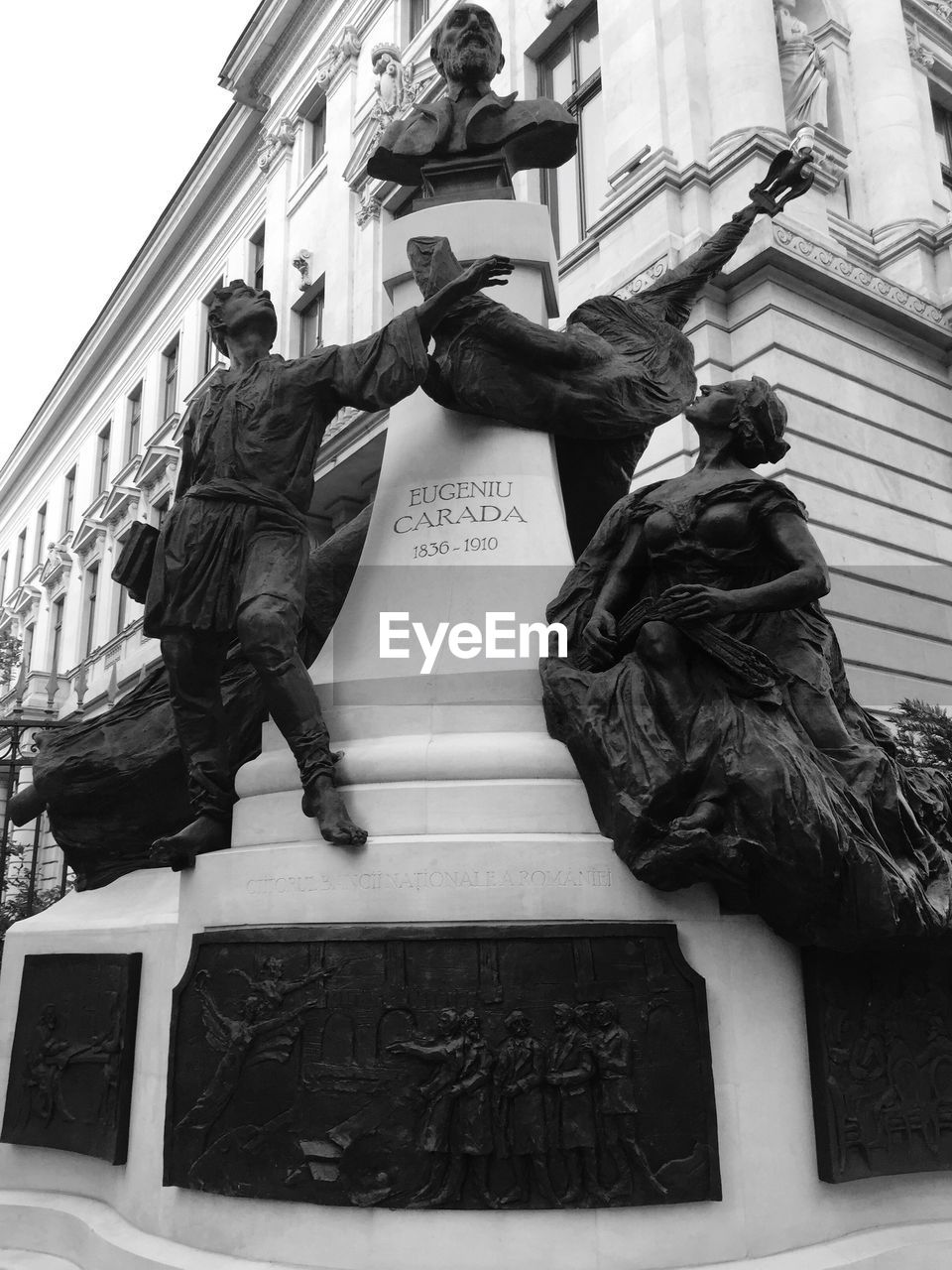 STATUE IN FRONT OF BUILDING IN CITY