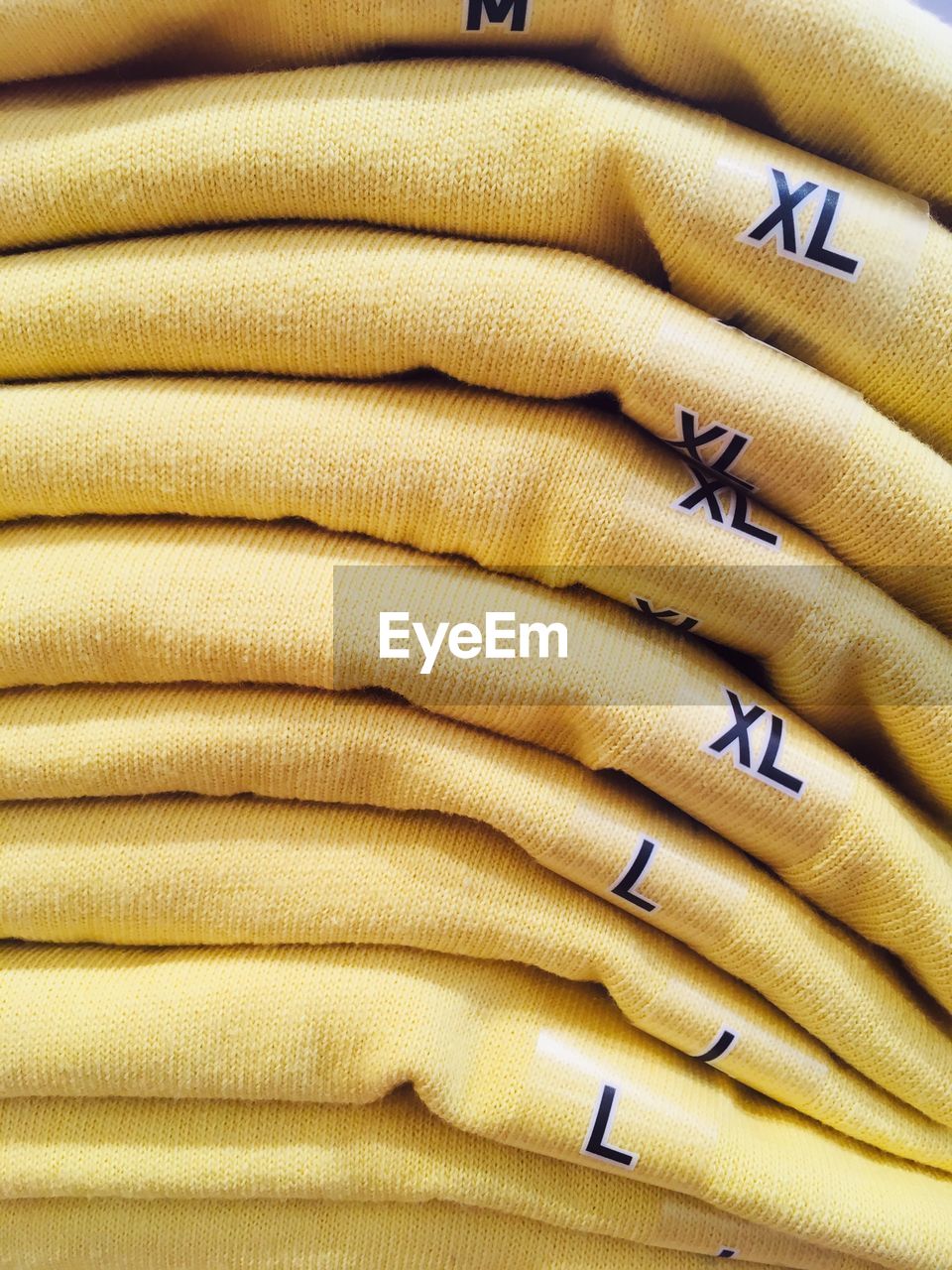 Full frame shot of yellow t-shirts