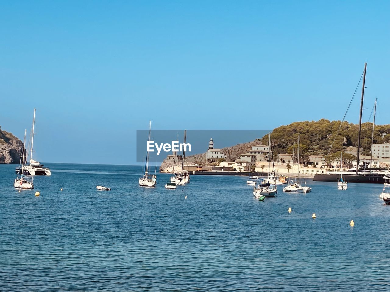 water, nautical vessel, sea, transportation, sailboat, mode of transportation, sky, ship, vehicle, mast, marina, nature, blue, harbor, clear sky, sailing, bay, coast, pole, boat, travel, no people, sailing ship, day, yacht, travel destinations, architecture, waterfront, beauty in nature, dock, scenics - nature, watercraft, ocean, land, moored, sunny, tall ship, city, outdoors, copy space, beach, tranquility, holiday, idyllic, tranquil scene, port, vacation, sunlight, building exterior, yachting, craft, shore, tourism, trip, built structure