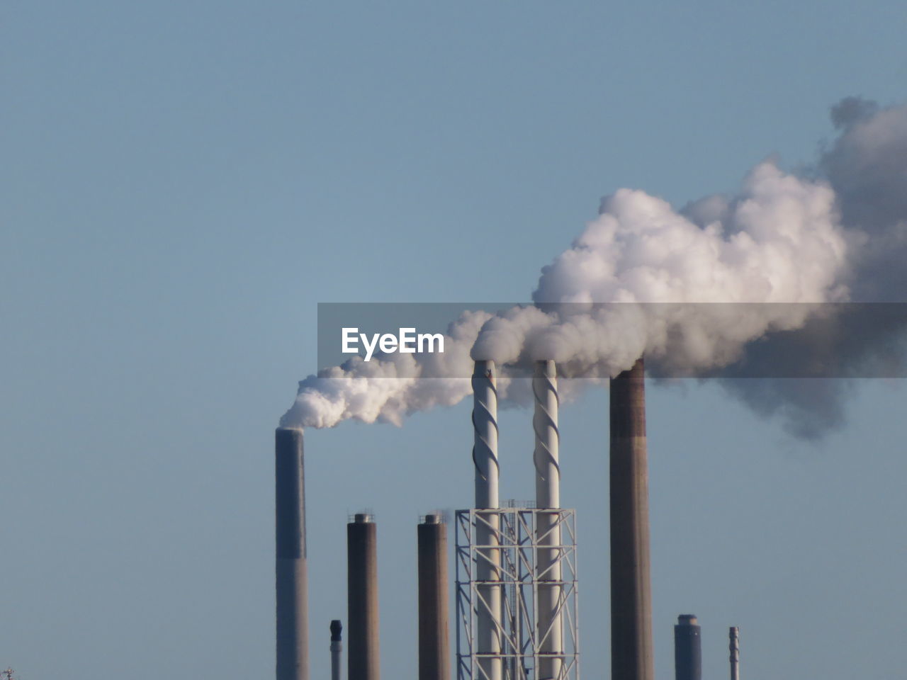 Smoke emitting from chimney against sky