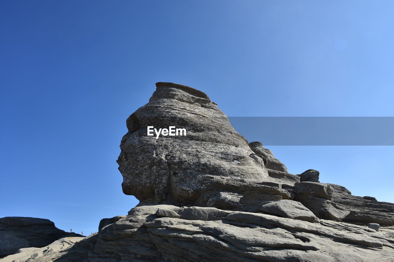 LOW ANGLE VIEW OF ROCK FORMATION