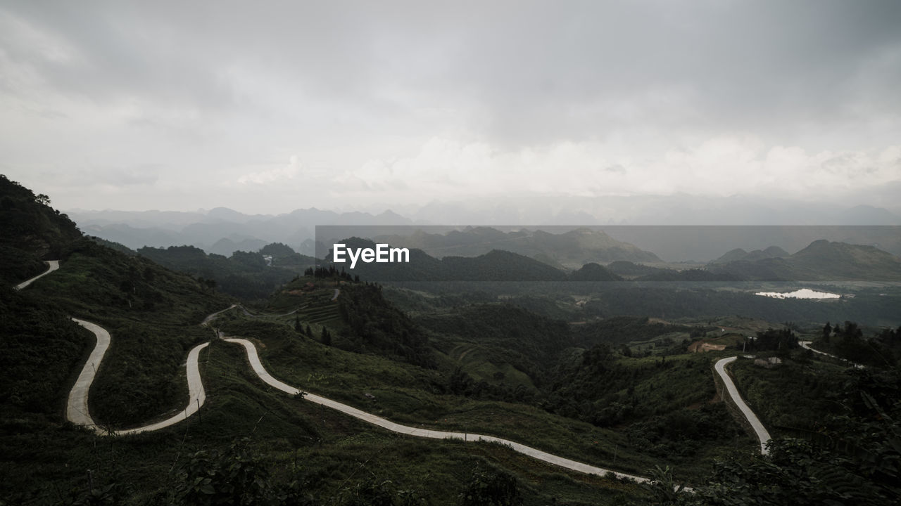 HIGH ANGLE VIEW OF MOUNTAIN ROAD AGAINST SKY