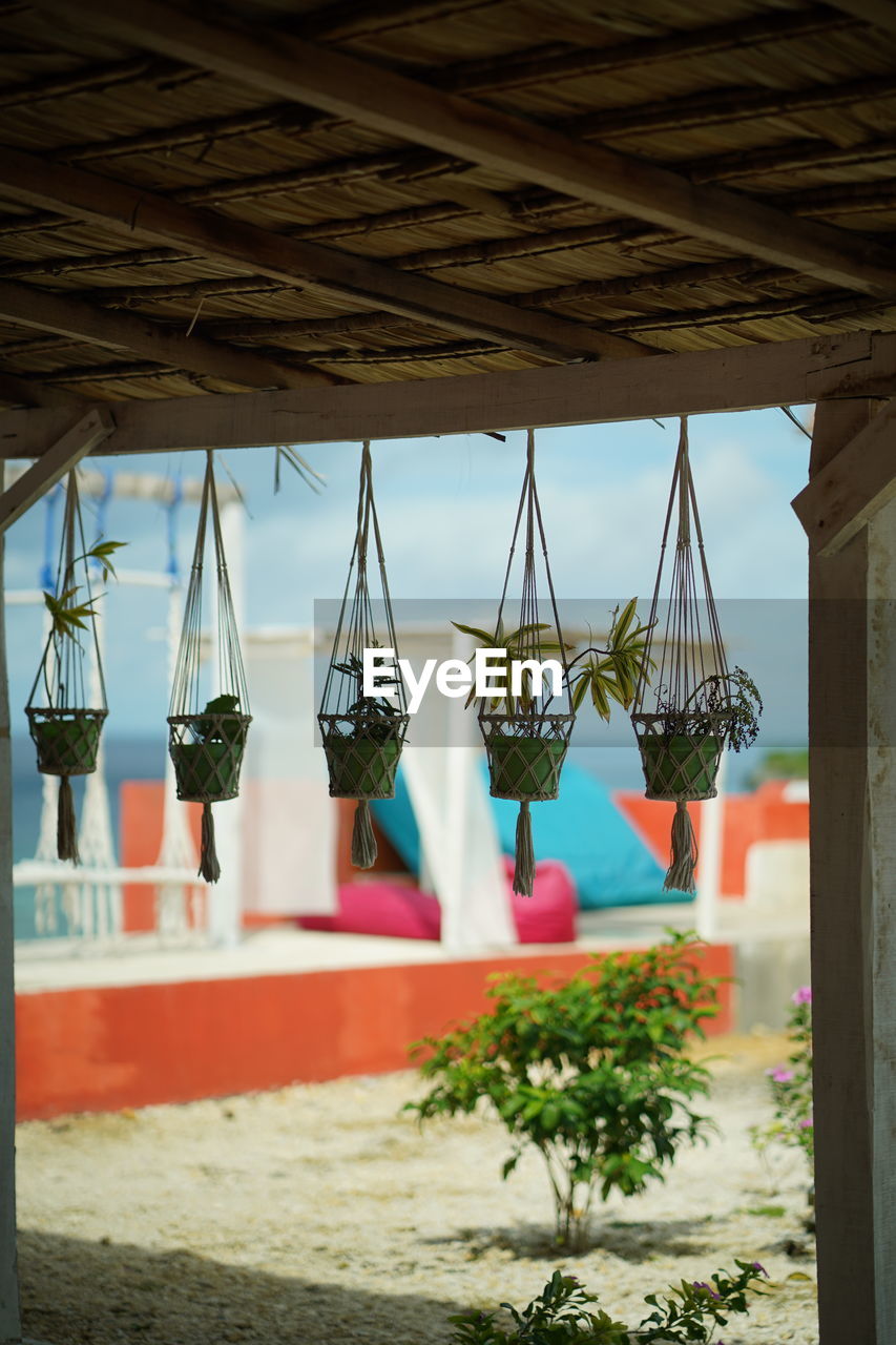 CLOSE-UP OF CLOTHES HANGING AT BEACH