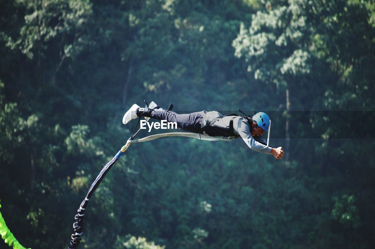 A man jumps from a cliff into the abyss