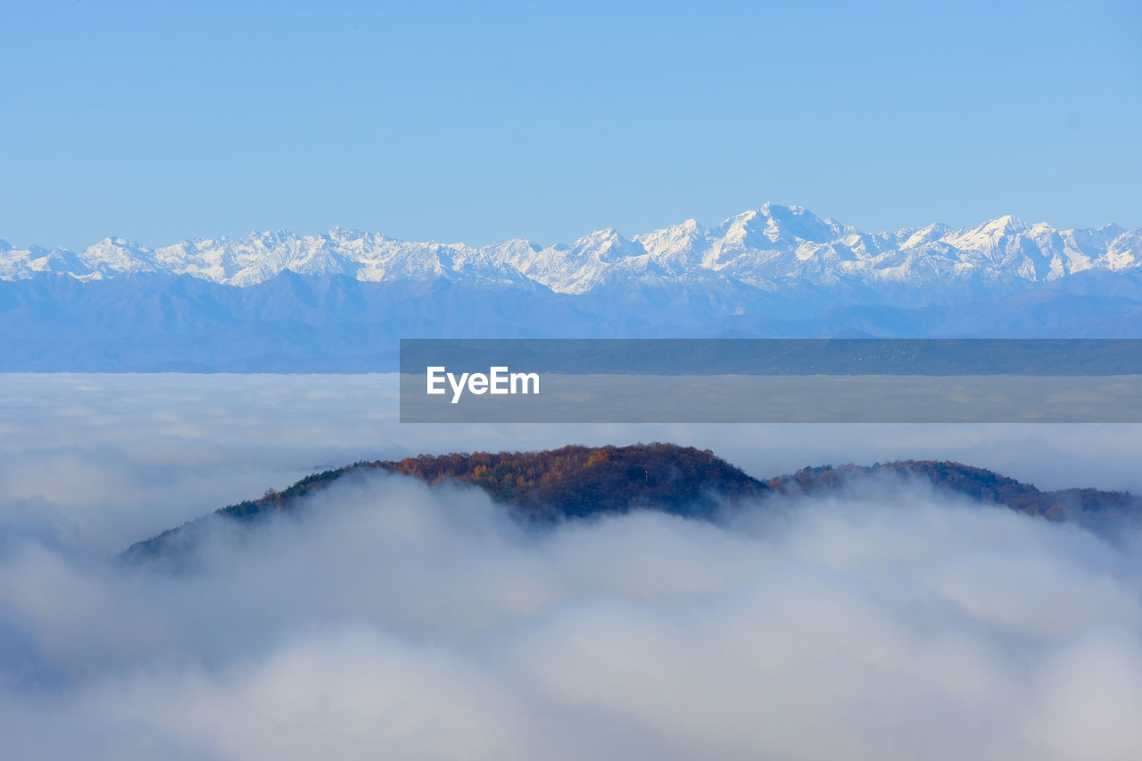 A sea of fog over the city of como and lake como, from a panoramic viewpoint in brunate.