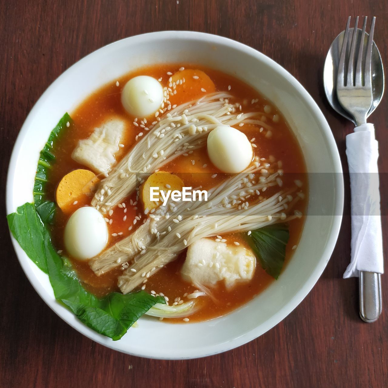 Tomyam soup in a bowl on the table.