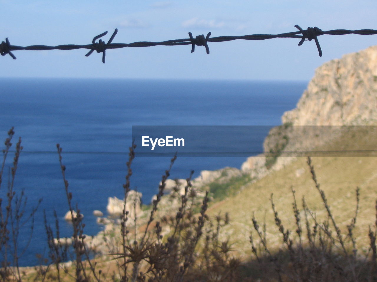 Barbed wire against sea